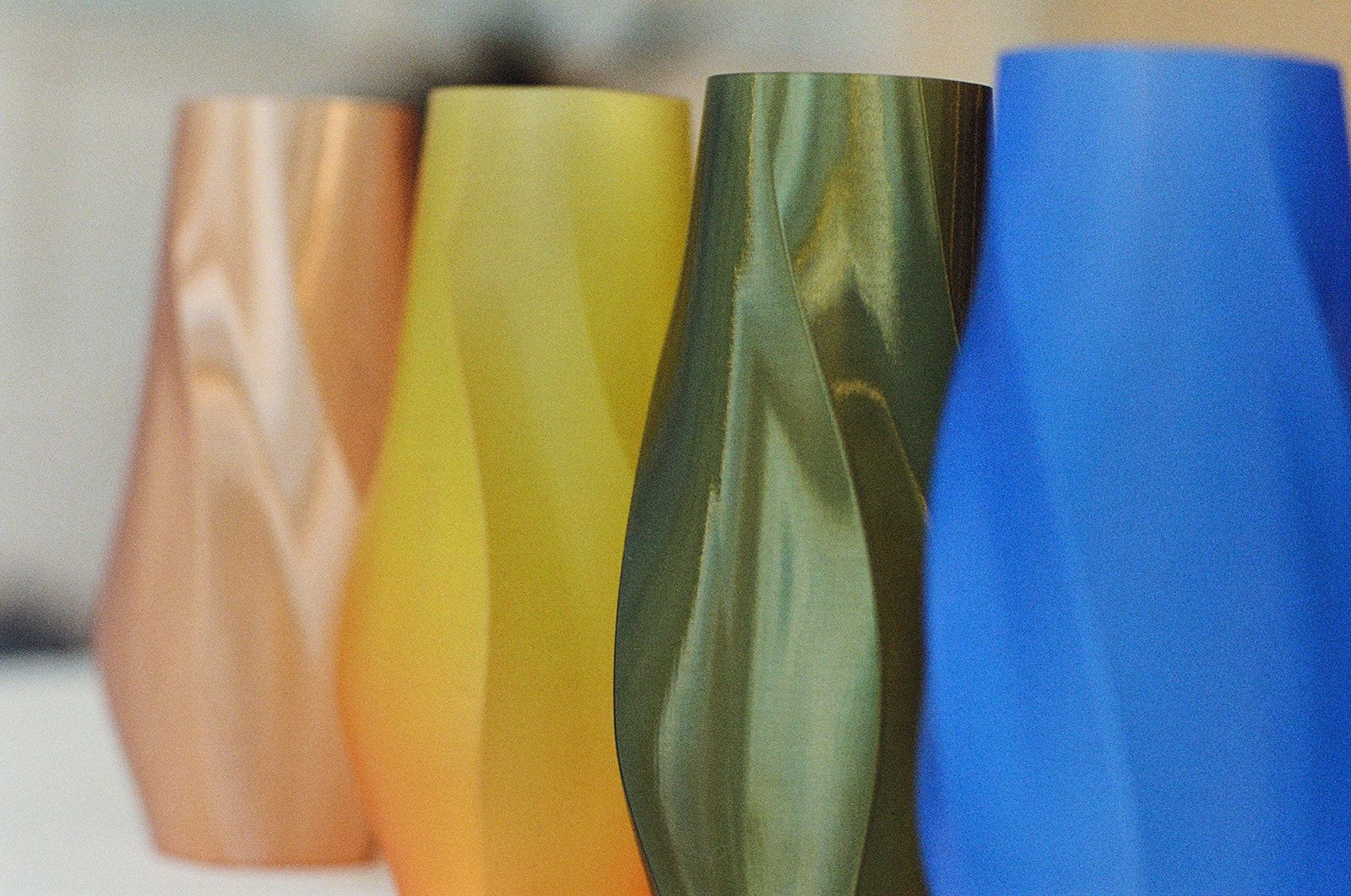 Four vases in peach, gradient, green and blue